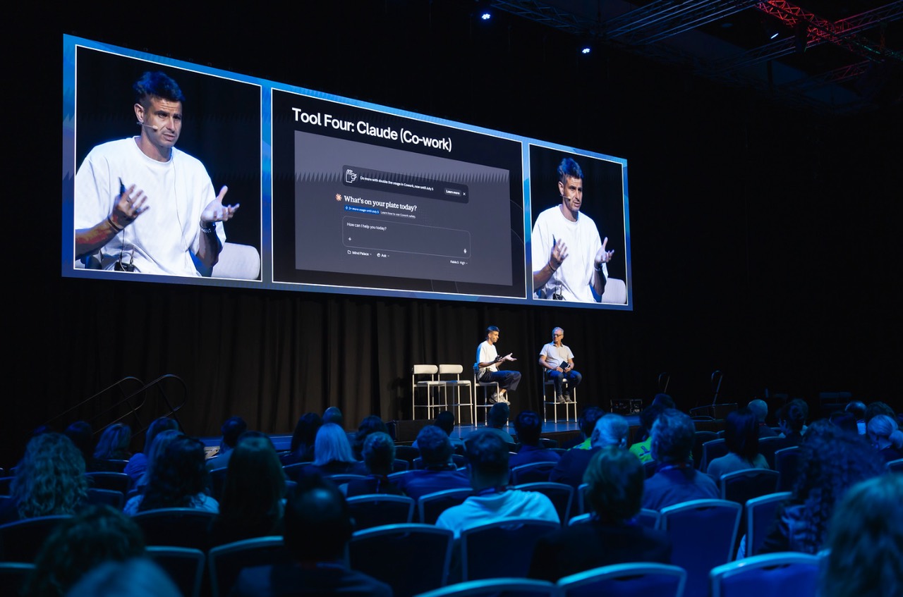 Oliver Green on stage at Arival, demoing Claude live to a full room of tour operators